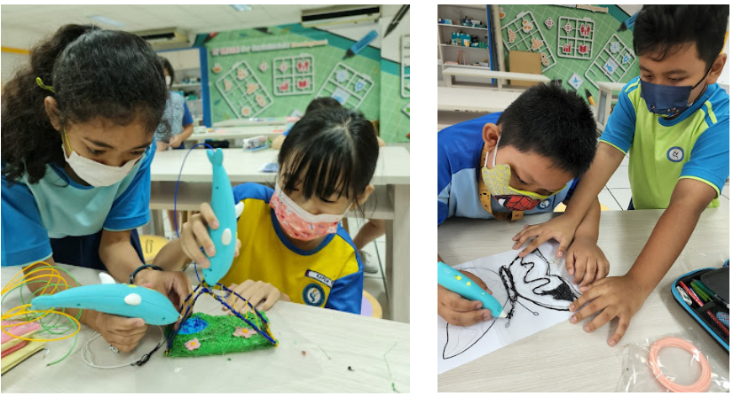 Children wearing masks use 3D pens to create colorful structures and trace drawings in a classroom.